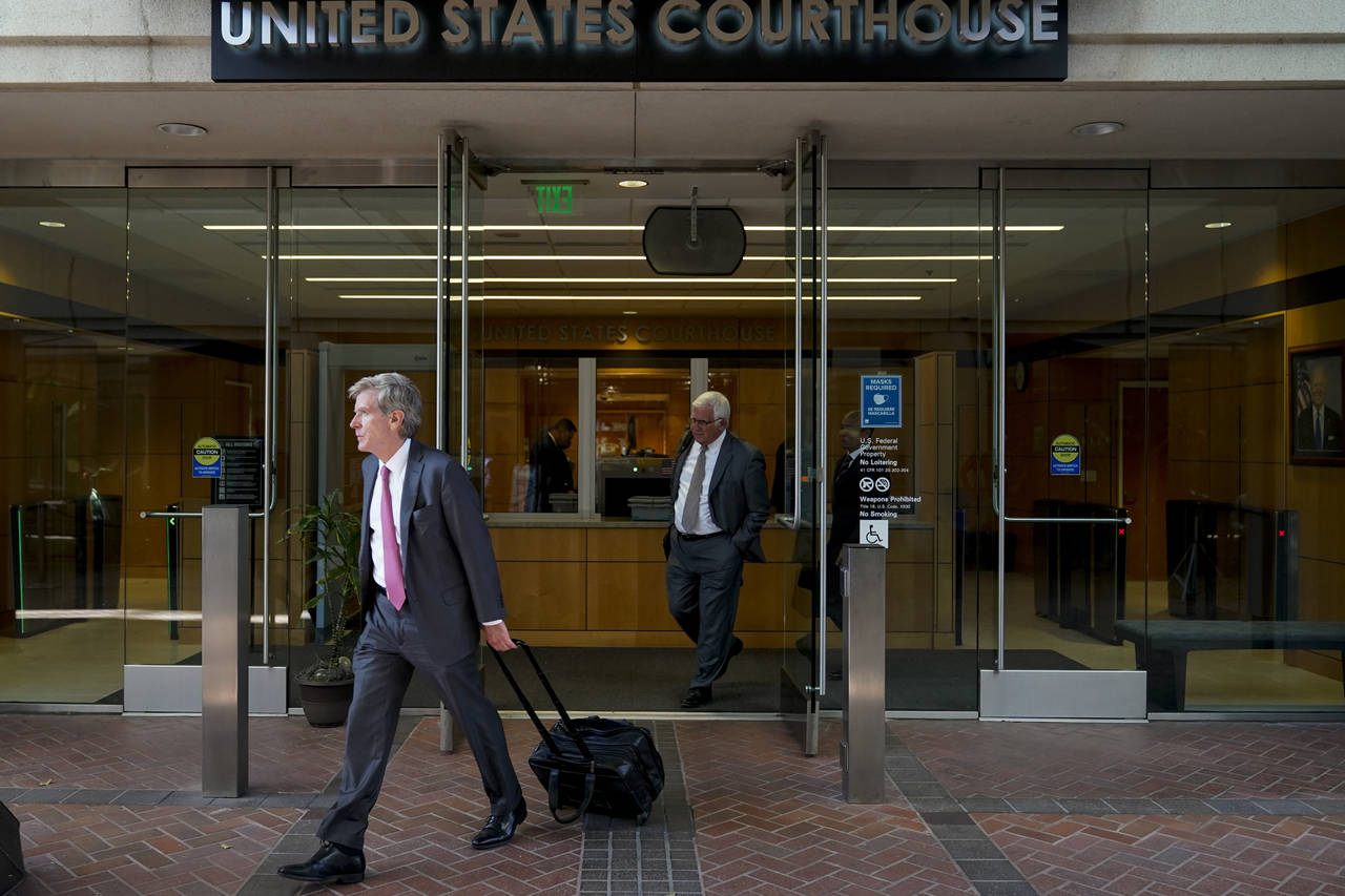 Robert Walters, front, attorney representing three LIV Golf players, leaves a federal courthouse in...
