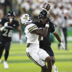 
              Vanderbilt wide receiver Devin Boddie Jr. (6) pulls in a catch over Hawaii defensive back Ty Marsh (4) during the second half of a NCAA college football game, Saturday, Aug. 27, 2022, in Honolulu. (AP Photo/Marco Garcia)
            
