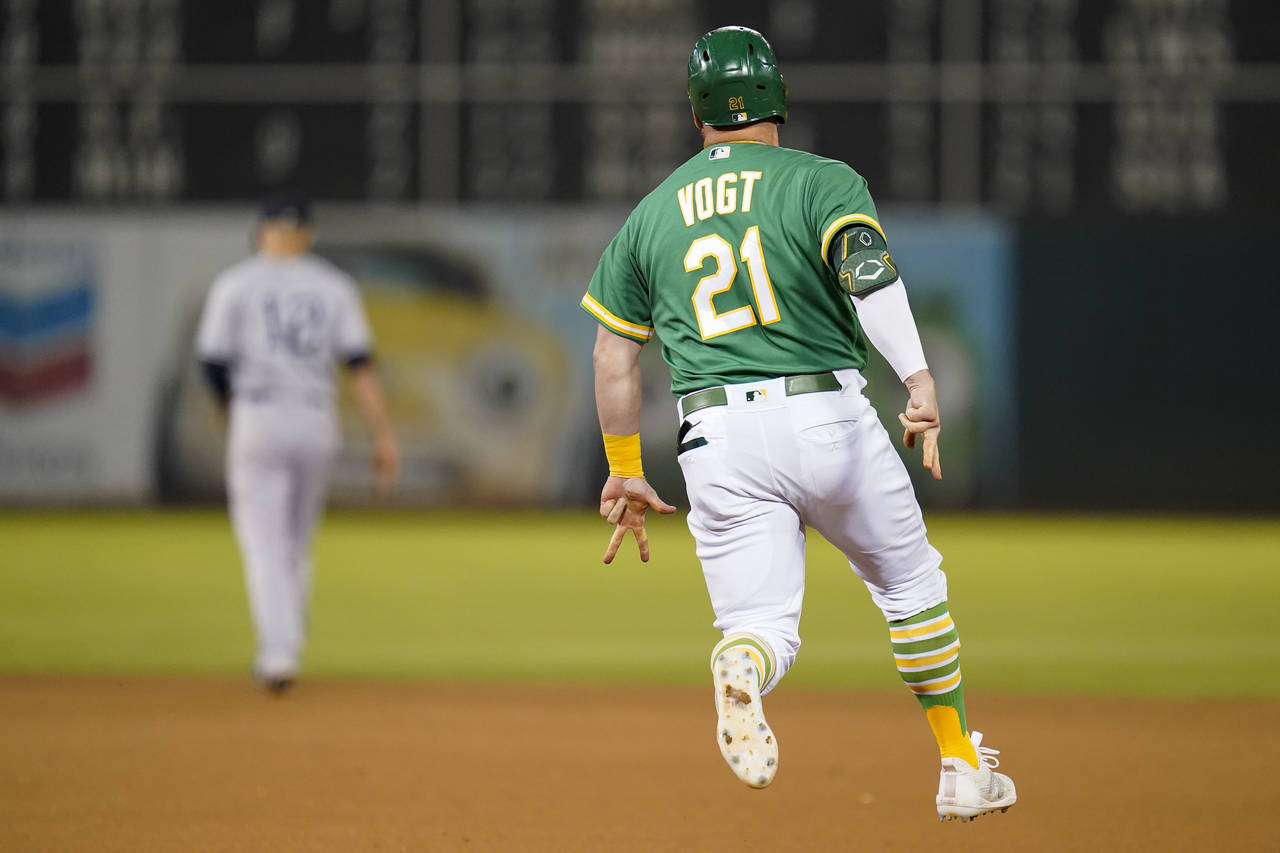 Oakland Athletics' Stephen Vogt (21) runs the bases after hitting a two-run home run against the Ne...