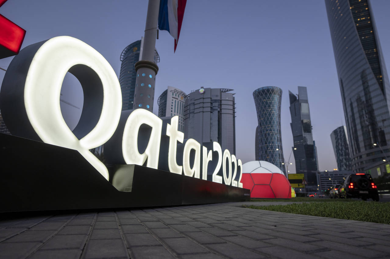 FILE - Branding is displayed near the Doha Exhibition and Convention Center, in Doha, Qatar, March ...