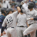 
              New York Yankees' Kyle Higashioka, right, greets Isiah Kiner-Falefa (12) at the plate after Higashioka hit a two-run home run to score Kiner-Falefa during the seventh inning of a baseball game, Wednesday, Aug. 10, 2022, in Seattle. (AP Photo/Ted S. Warren)
            