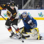 
              Finland's goalie Leevi Merilainen (1) makes the save on Germany's Josef Eham (18) during the second period in the quarterfinals of world junior hockey championship in Edmonton, Alberta,  Wednesday, Aug. 17, 2022. (Jason Franson/The Canadian Press via AP)
            