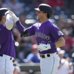 
              Colorado Rockies' Randal Grichuk, left, congratulates Ryan McMahon who crosses home plate after hitting a solo home run off St. Louis Cardinals relief pitcher Genesis Cabrera in the seventh inning of a baseball game Thursday, Aug. 11, 2022, in Denver. (AP Photo/David Zalubowski)
            