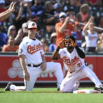 
              Baltimore Orioles' Cedric Mullins, right, reacts after hitting a triple against the Chicago Cubs in the third inning of a baseball game, Thursday, Aug. 18, 2022, in Baltimore. (AP Photo/Gail Burton)
            