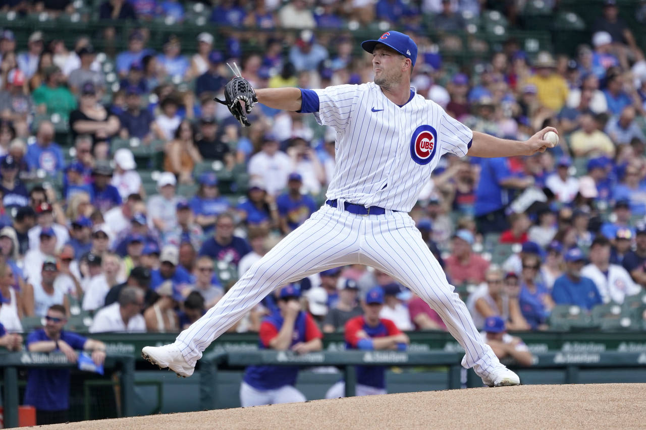 Chicago Cubs starting pitcher Drew Smyly winds up during the first inning of a baseball game agains...