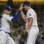
              Los Angeles Dodgers relief pitcher Evan Phillips, right, celebrates with center fielder Trayce Thompson, left, after the team's baseball game against the Miami Marlins in Los Angeles, Friday, Aug. 19, 2022. The Dodgers won 2-1. (AP Photo/Alex Gallardo)
            
