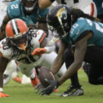 
              Jacksonville Jaguars cornerback Shaquill Griffin (26) recovers fumble by Cleveland Browns running back D'Ernest Johnson (30) during the first half of an NFL preseason football game, Friday, Aug. 12, 2022, in Jacksonville, Fla. (AP Photo/Phelan M. Ebenhack)
            