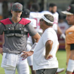 
              Tampa Bay Buccaneers quarterback Tom Brady (12) talks to coach Clyde Christensen during an NFL football training camp practice with the Miami Dolphins Wednesday, Aug. 10, 2022, in Tampa, Fla. (AP Photo/Chris O'Meara)
            