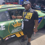 
              James Bromsey III, a sixth-grader at LeBron James' I Promise School in Akron, Ohio, looks at NASCAR driver Chris Buescher's car, Sunday, Aug. 7, 2022 in Brooklyn, Mich. Bromsey was given an all-access tour of Michigan International Speedway in Brooklyn, Mich., on Sunday. Chris Buescher’s No. 17 Ford had a paint job that highlighted the LeBron James Family Foundation. (AP Photo/Larry Lage)
            
