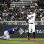 
              Minnesota Twins shortstop Carlos Correa, right, celebrates after doubling off Texas Rangers' Charlie Culberson at second base after Brad Miller lined out, to end the baseball game Friday, Aug. 19, 2022, in Minneapolis. The Twins won 2-1. (AP Photo/Craig Lassig)
            