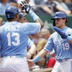 
              Kansas City Royals' Salvador Perez (13) congratulates Michael Massey (19) after Massey scored on a balk by Boston Red Sox pitcher Kutter Crawford during the third inning of a baseball game in Kansas City, Mo., Sunday, Aug. 7, 2022. (AP Photo/Colin E. Braley)
            