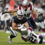 
              Las Vegas Raiders tight end Cole Fotheringham (85) is tackled by New England Patriots safety Adrian Phillips (21) during the first half of an NFL preseason football game, Friday, Aug. 26, 2022, in Las Vegas. (AP Photo/Ashley Landis)
            