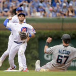 
              Chicago Cubs second baseman Nick Madrigal, left, turns a double play over Miami Marlins' JJ Bleday (67) to end the first inning of a baseball game, Sunday, Aug. 7, 2022, at Wrigley Field in Chicago. (AP Photo/Mark Black)
            