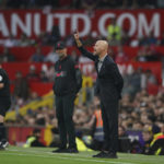 
              Manchester United's head coach Erik ten Hag gestures as Liverpool's manager Jurgen Klopp watches him in background during the English Premier League soccer match between Manchester United and Liverpool at Old Trafford stadium, in Manchester, England, Monday, Aug 22, 2022. (AP Photo/Dave Thompson)
            