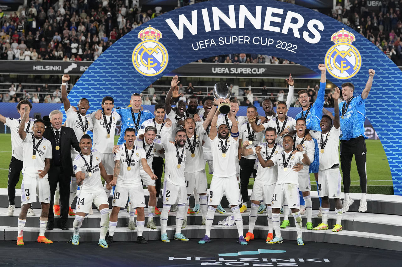 Real Madrid's Karim Benzema lifts the trophy after winning the UEFA Super Cup final soccer match be...