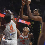 
              Dallas Wings center Teaira McCowan (7) pulls down a rebound over Connecticut Sun guard Nia Clouden (11) and center Brionna Jones (42) during Game 2 of a WNBA basketball first-round playoff series Sunday, Aug. 21, 2022, in Uncasville, Conn. (Sean D. Elliot/The Day via AP)
            