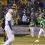 
              Oakland Athletics' Stephen Vogt (21) runs the bases after hitting a two-run home run against New York Yankees relief pitcher Ron Marinaccio, foreground, during the 10th inning of a baseball game in Oakland, Calif., Saturday, Aug. 27, 2022. (AP Photo/Godofredo A. Vásquez)
            