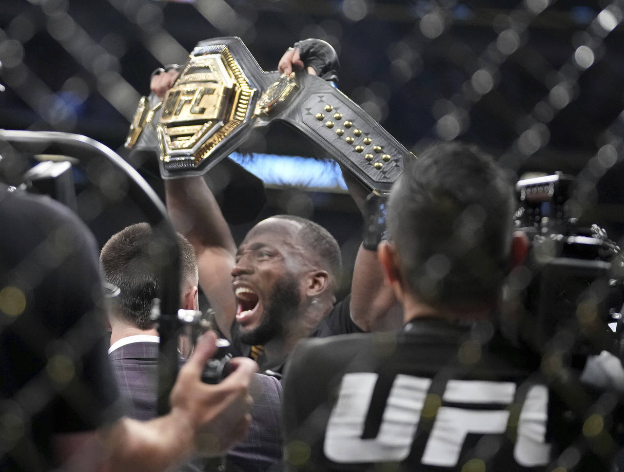 UFC fighter Leon Edwards, of Jamaica, celebrates his title as welterweight champion of the world af...