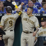 
              San Diego Padres manager Bob Melvin, right, looks on as Jake Cronenworth (9) celebrates with Manny Machado, center, after Cronenworth hit a home run during the third inning of baseball game against the Kansas City Royals in Kansas City, Mo., Friday, Aug. 26, 2022. (AP Photo/Colin E. Braley)
            