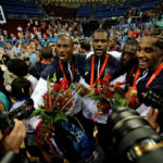 
              FILE - Kobe Bryant, from left, LeBron James, Dwyane Wade and Carmelo Anthony, of the U.S. Olympic basketball team, are surrounded by photographers as they celebrate after beating Spain 118-107 in the men's gold medal basketball game at the Beijing 2008 Olympics in Beijing. A documentary on the 2008 U.S. men’s basketball team known as the “Redeem Team,” with executive producers including Lebron James and Dwayne Wade, will premiere on Netflix in October. (AP Photo/Dusan Vranic, File)
            