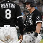 
              Chicago White Sox's Andrew Vaughn, right, talks with first base coach Daryl Boston after hitting a two-run single during the seventh inning of a baseball game against the Detroit Tigers in Chicago, Friday, Aug. 12, 2022. (AP Photo/Nam Y. Huh)
            