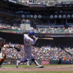 
              Los Angeles Dodgers' Mookie Betts (50) hits a three-run home run in front of San Francisco Giants catcher Austin Wynns during the fourth inning of a baseball game in San Francisco, Thursday, Aug. 4, 2022. (AP Photo/Jeff Chiu)
            