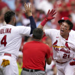 
              St. Louis Cardinals' Lars Nootbaar (21) is congratulated by teammate Yadier Molina (4) after hitting a walk-off single during the ninth inning to defeat the Chicago Cubs 4-3 in the first game of a baseball doubleheader Thursday, Aug. 4, 2022, in St. Louis. (AP Photo/Jeff Roberson)
            