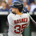 
              Boston Red Sox's Eric Hosmer follows through on an RBI double during the second inning of the team's baseball against the Kansas City Royals, Friday, Aug. 5, 2022, in Kansas City, Mo. (AP Photo/Reed Hoffmann)
            