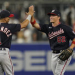 
              Washington Nationals right fielder Alex Call (62) celebrates with second baseman Cesar Hernandez after the Nationals defeated the San Diego Padres 6-3 in a baseball game Friday, Aug. 19, 2022, in San Diego. (AP Photo/Gregory Bull)
            