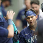 
              Seattle Mariners' Sam Haggerty is greeted in the dugout after he hit a solo home run to break up New York Yankees starting pitcher Nestor Cortes' no-hitter during the sixth inning of a baseball game, Wednesday, Aug. 10, 2022, in Seattle. (AP Photo/Ted S. Warren)
            