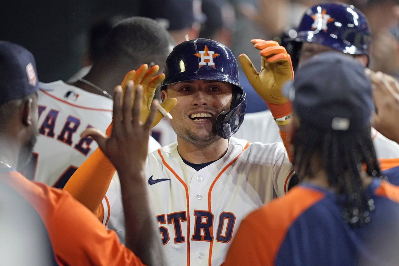 Houston Astros' Aledmys Diaz celebrates with teammates in the dugout after hitting a grand slam aga...