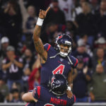 
              FILE - Houston Texans quarterback Deshaun Watson (4) is lifted by center Nick Martin (66) as they celebrate a touchdown against the New England Patriots during the first half of an NFL football game Sunday, Dec. 1, 2019, in Houston. The NFL suspended Watson for six games on Monday, Aug. 1, 2022 for violating its personal conduct policy following accusations of sexual misconduct made against him by two dozen women in Texas, two people familiar with the decision said. (AP Photo/Eric Christian Smith, File)
            