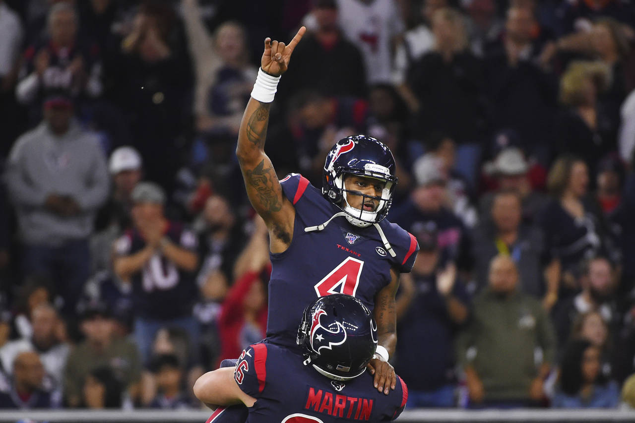 FILE - Houston Texans quarterback Deshaun Watson (4) is lifted by center Nick Martin (66) as they c...