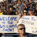
              Fans hold signs as Serena Williams, of the United States, arrives on court for a match against Belinda Bencic, of Switzerland, during the National Bank Open tennis tournament Wednesday, Aug. 10, 2022, in Toronto. (Nathan Denette/The Canadian Press via AP)
            