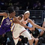 
              Los Angeles Sparks forward Nneka Ogwumike, left, and Connecticut Sun center Brionna Jones go after a rebound during the first half of a WNBA basketball game Thursday, Aug. 11, 2022, in Los Angeles. (AP Photo/Mark J. Terrill)
            
