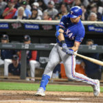 
              Texas Rangers' Nate Lowe hits an RBI-single against Minnesota Twins pitcher Caleb Thielbar during the sixth inning of a baseball game Friday, Aug. 19, 2022, in Minneapolis. Rangers' Bubba Thompson scored. (AP Photo/Craig Lassig)
            