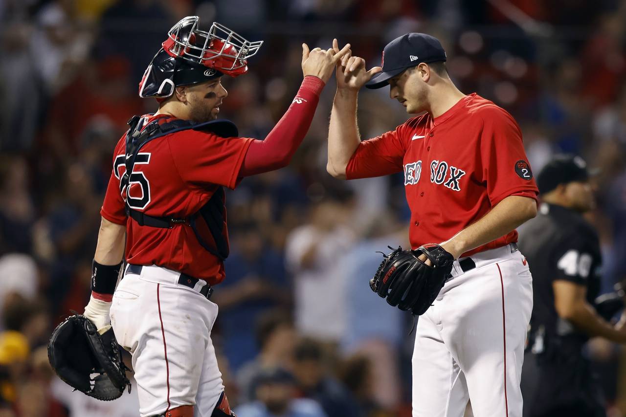 Boston Red Sox's Garrett Whitlock, right, and Kevin Plawecki, left, celebrate after defeating the T...