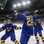 
              Sweden's Oskar Magnusson (28) celebrates a goal against Germany with Victor Stjernborg (19) and Linus Sjodin (18) during the first period of an IIHF world junior hockey championships game Monday, Aug. 15, 2022, in Edmonton, Alberta. (Jason Franson/The Canadian Press via AP)
            
