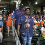 
              The parents of Houston Astros' Yordan Alvarez, Agustín Eduardo Álvarez Salazar, rear, and Mailyn Cadogan Reyes walk to their seats to watch the Minnesota Twins and Houston Astros play a baseball game Tuesday, Aug. 23, 2022, in Houston. Alvarez's parents got to see him play as a professional for the first time Tuesday night after arriving from Cuba Friday. (AP Photo/David J. Phillip)
            