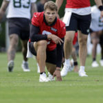 
              New York Jets quarterback Zach Wilson takes part in drills at the NFL football team's practice facility in Florham Park, N.J., Thursday, July 28, 2022. (AP Photo/Adam Hunger)
            