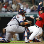 
              Cleveland Guardians' Owen Miller scores past Houston Astros catcher Martin Maldonado on a single by Luke Maile during the seventh inning of a baseball game Friday, Aug. 5, 2022, in Cleveland. (AP Photo/Ron Schwane)
            