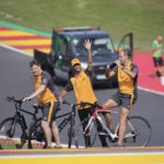 
              McLaren driver Daniel Ricciardo of Australia, center, waves as he rides a bike on the track with members of his team ahead of the Formula One Grand Prix at the Spa-Francorchamps racetrack in Spa, Belgium, Thursday, Aug. 25, 2022. The Belgian Formula One Grand Prix will take place on Sunday. (AP Photo/Olivier Matthys)
            