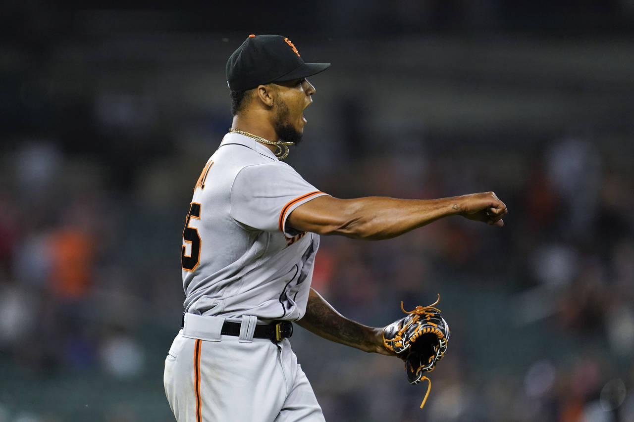 San Francisco Giants relief pitcher Camilo Doval reacts to the final out against the Detroit Tigers...