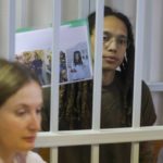 
              WNBA star and two-time Olympic gold medalist Brittney Griner holds up images as she stands behind bars in a courtroom for a hearing, in Khimki just outside Moscow, Russia, Tuesday, Aug. 2, 2022. Since Brittney Griner last appeared in her trial for cannabis possession, the question of her fate expanded from a tiny and cramped courtroom on Moscow's outskirts to the highest level of Russia-US diplomacy. (Evgenia Novozhenina/Pool Photo via AP)
            