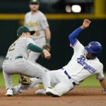 
              Oakland Athletics shortstop Nick Allen (2) applies the tag on Texas Rangers' Marcus Semien at second on a stolen base attempt in the first inning of a baseball game, Thursday, Aug. 18, 2022, in Arlington, Texas. (AP Photo/Tony Gutierrez)
            