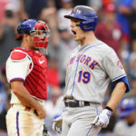 
              New York Mets' Mark Canha, right, reacts past Philadelphia Phillies catcher J.T. Realmuto after hitting a two-run home run during the ninth inning of a baseball game, Sunday, Aug. 21, 2022, in Philadelphia. (AP Photo/Matt Slocum)
            