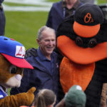 
              Former President George W. Bush, center, is surrounded by mascots during pre-game festivities before the MLB Little League Classic baseball game between the Baltimore Orioles and the Boston Red Sox in Williamsport, Pa., Sunday, Aug. 21, 2022. (AP Photo/Gene J. Puskar)
            