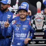 
              Kyle Larson poses for photos with the trophy and his team after winning a NASCAR Cup Series auto race in Watkins Glen, N.Y., Sunday, Aug. 21, 2022. (AP Photo/Seth Wenig)
            