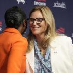 
              Carrie Walton Penner, right, greets Mellody Hobson during a news conference at Denver Broncos headquarters Wednesday, Aug. 10, 2022, in Centennial, Colo. Hobson is a limited partner in the Walton Penner ownership group that purchased the NFL football team. (AP Photo/David Zalubowski)
            