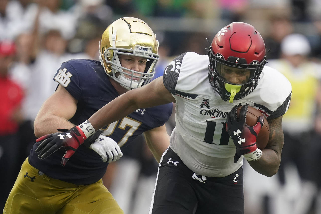 FILE - Cincinnati's Leonard Taylor (11) is chased by Notre Dame's JD Bertrand (27) during the secon...